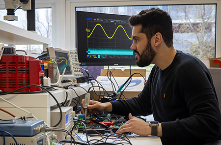 A member of tepeo staff is working on some electrics for their electric boilers.