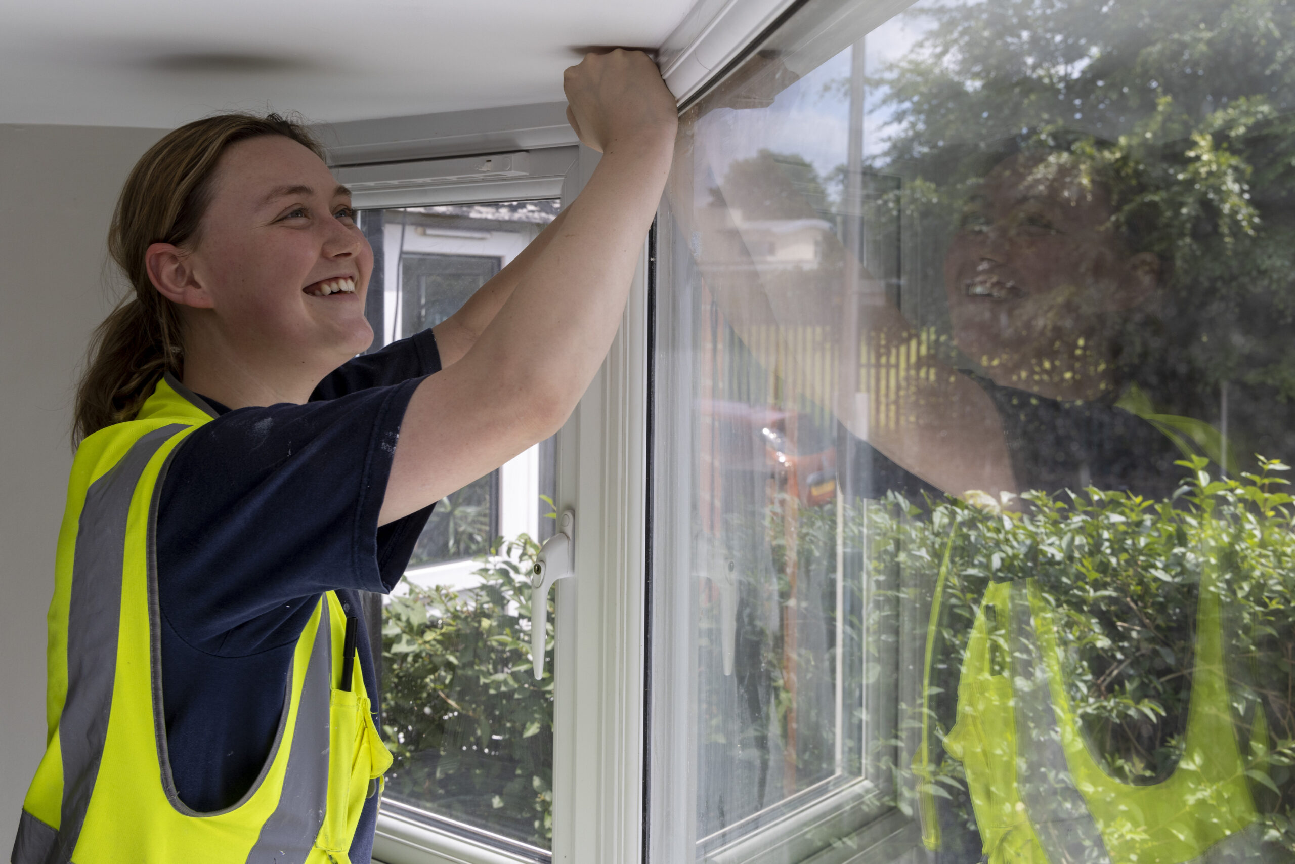 A woman draugh proofing a window