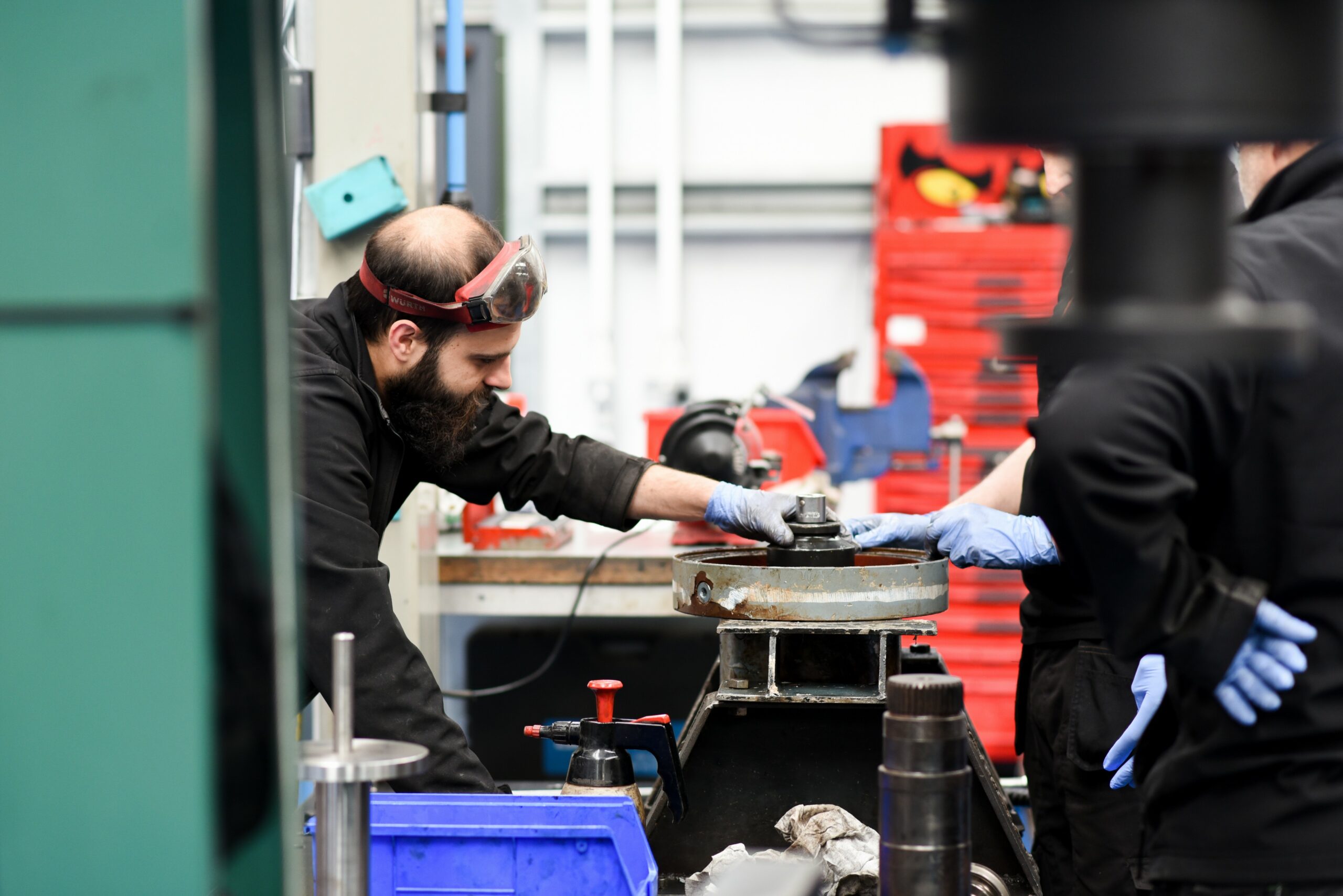 A photo of a male working on wind turbine parts at Renewable Parts