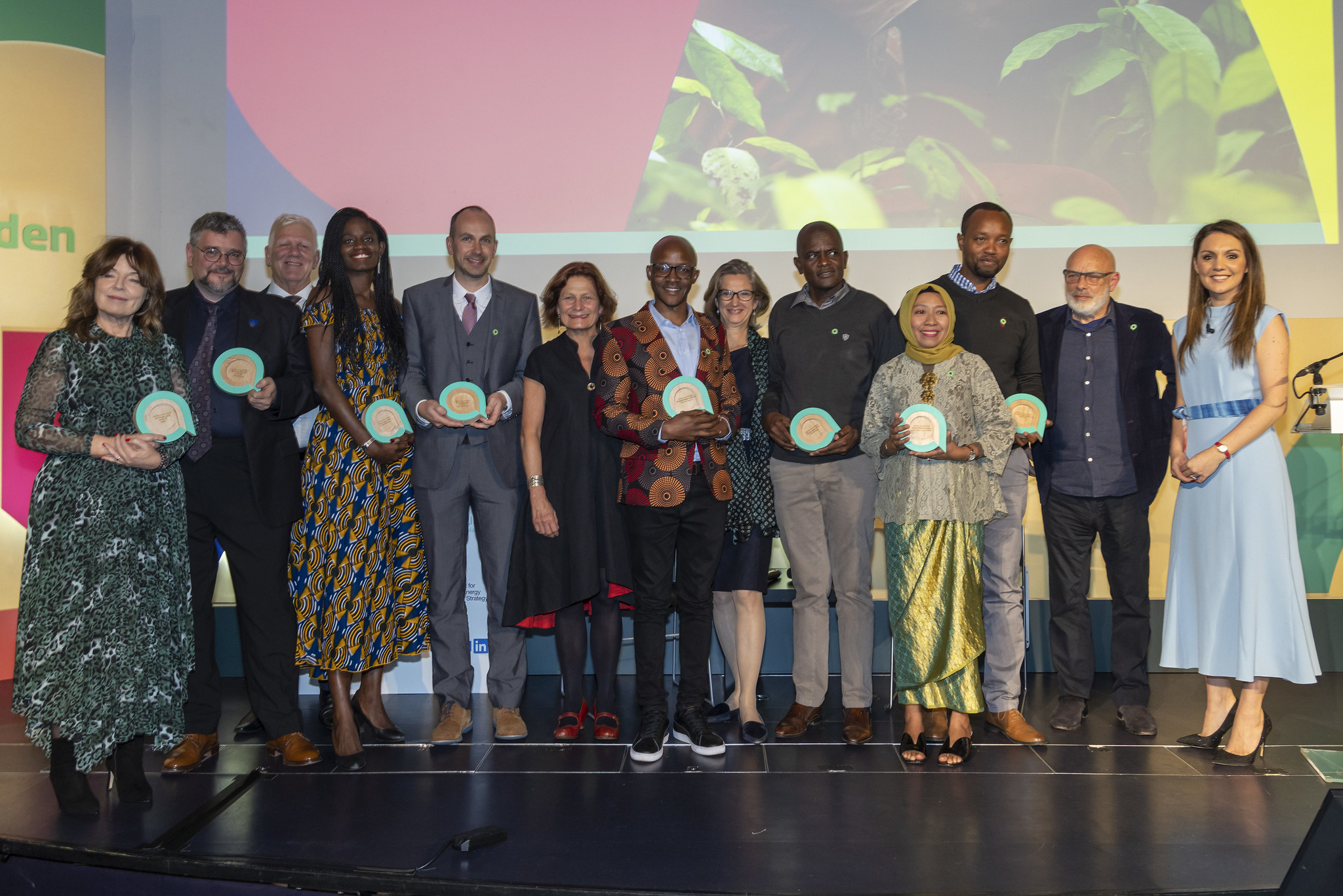 People stand on stage with awards.