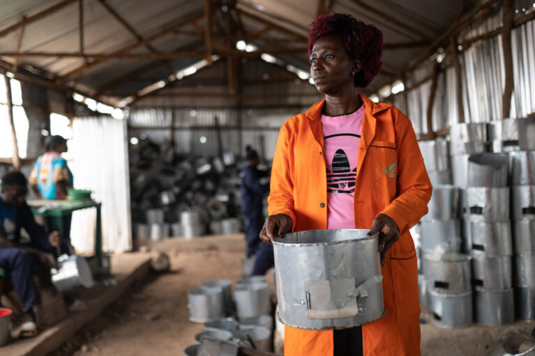 USAFI Green Energy employee making cookstoves
