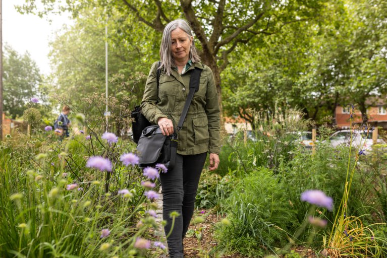 Woman walking through community garden