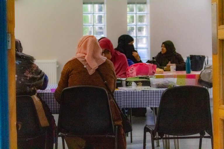 Women sitting around tables and talking
