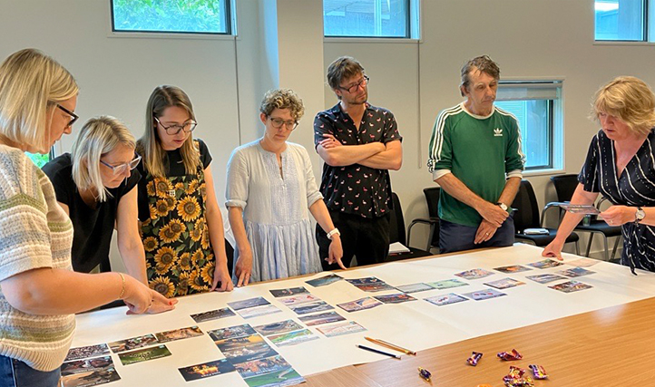 A classroom full of teachers are leaning about how their school can become carbon zero.