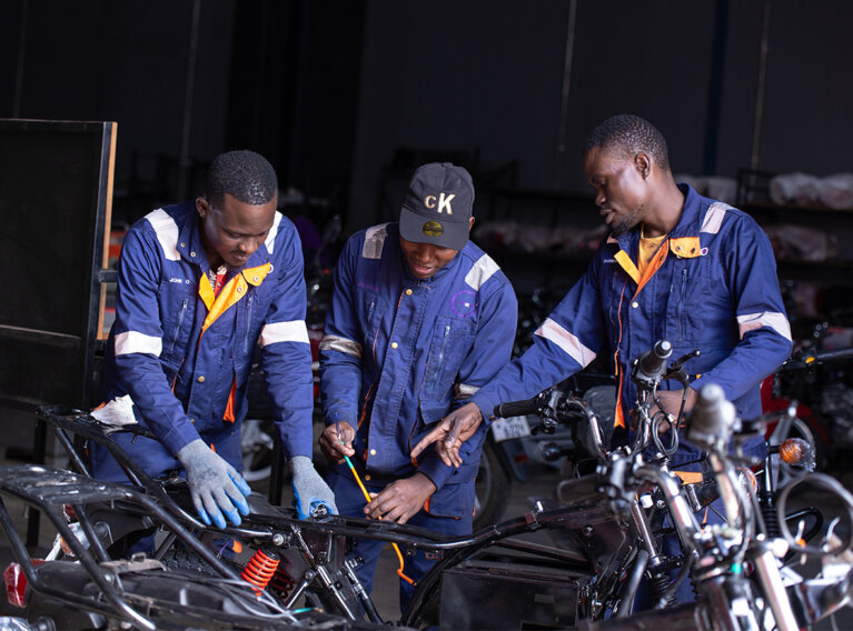 Portraits of Obonyo John (28) on the left, Sowedi Kaziro (24) in the middle and Wandera Rogers (29) on the right at work in one of GOGO's sites in Nakawa, Kampala - Uganda. Obonyo is an assembling technician, Sowedi works in the assembling and production unit while Wandera is a Quality Inspector.