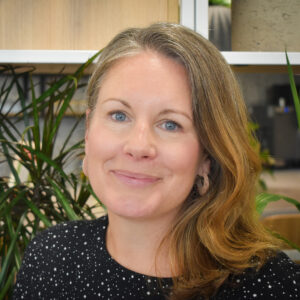 Woman wearing a black top smiling at the camera