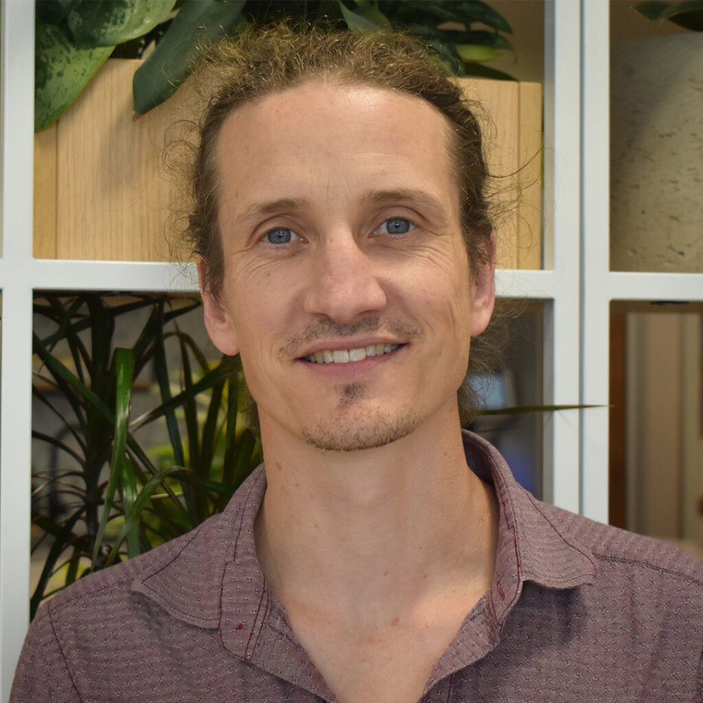 Man in a shirt smiling at camera