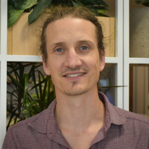 Man in a shirt smiling at camera