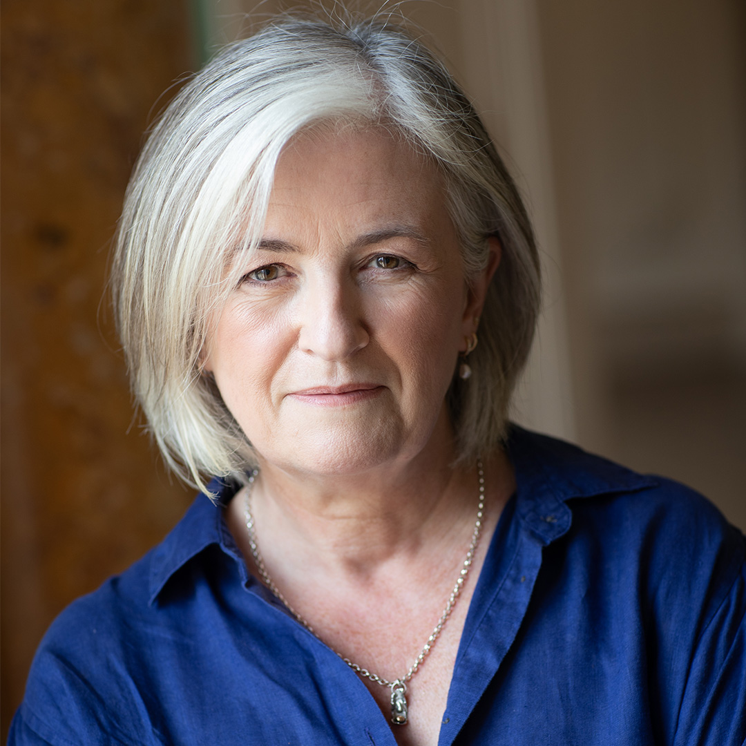 A portrait of Jo Walton smiling at the camera.