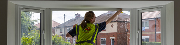 Woman insulating a window