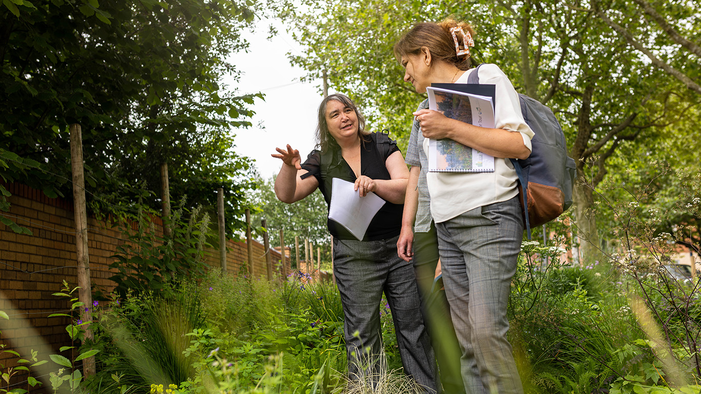 Two women outside in nature talking to each other