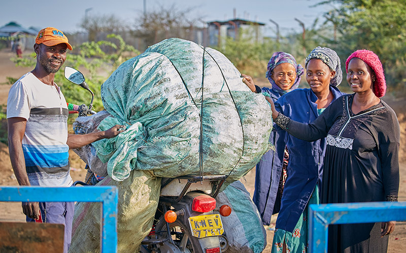 Community members of Rafiki Wa Mazingira are transporting produces biochar briquettes, a more affordable and environmentally friendly alternative to wood-based charcoal.