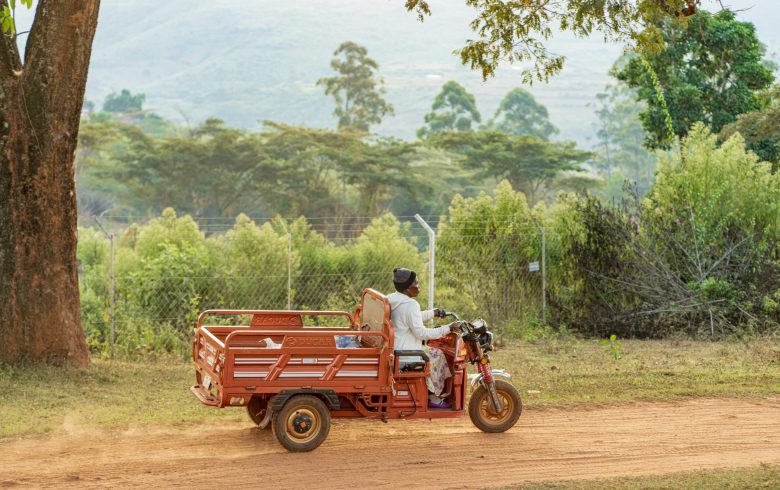 A woman in Africa is driving a clean energy scooter from Mobility Africa